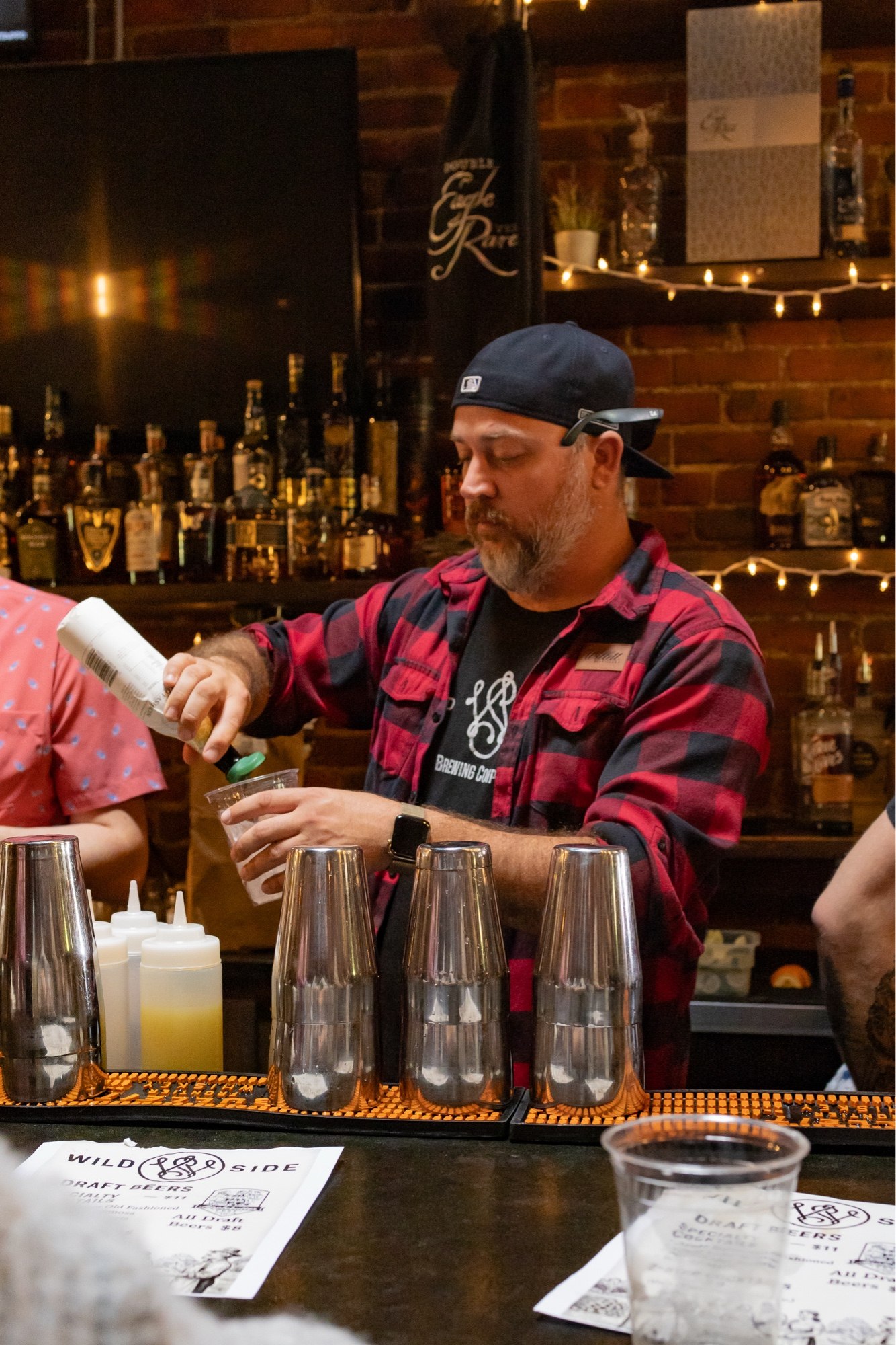 Nick Scott mixing drinks behind the bar at Wild Side Brewing