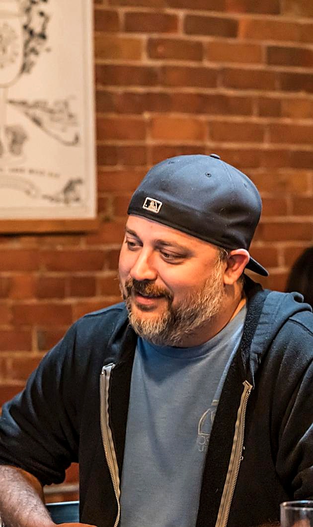 Nick Scott, standing behind the bar at Wild Side Brewing