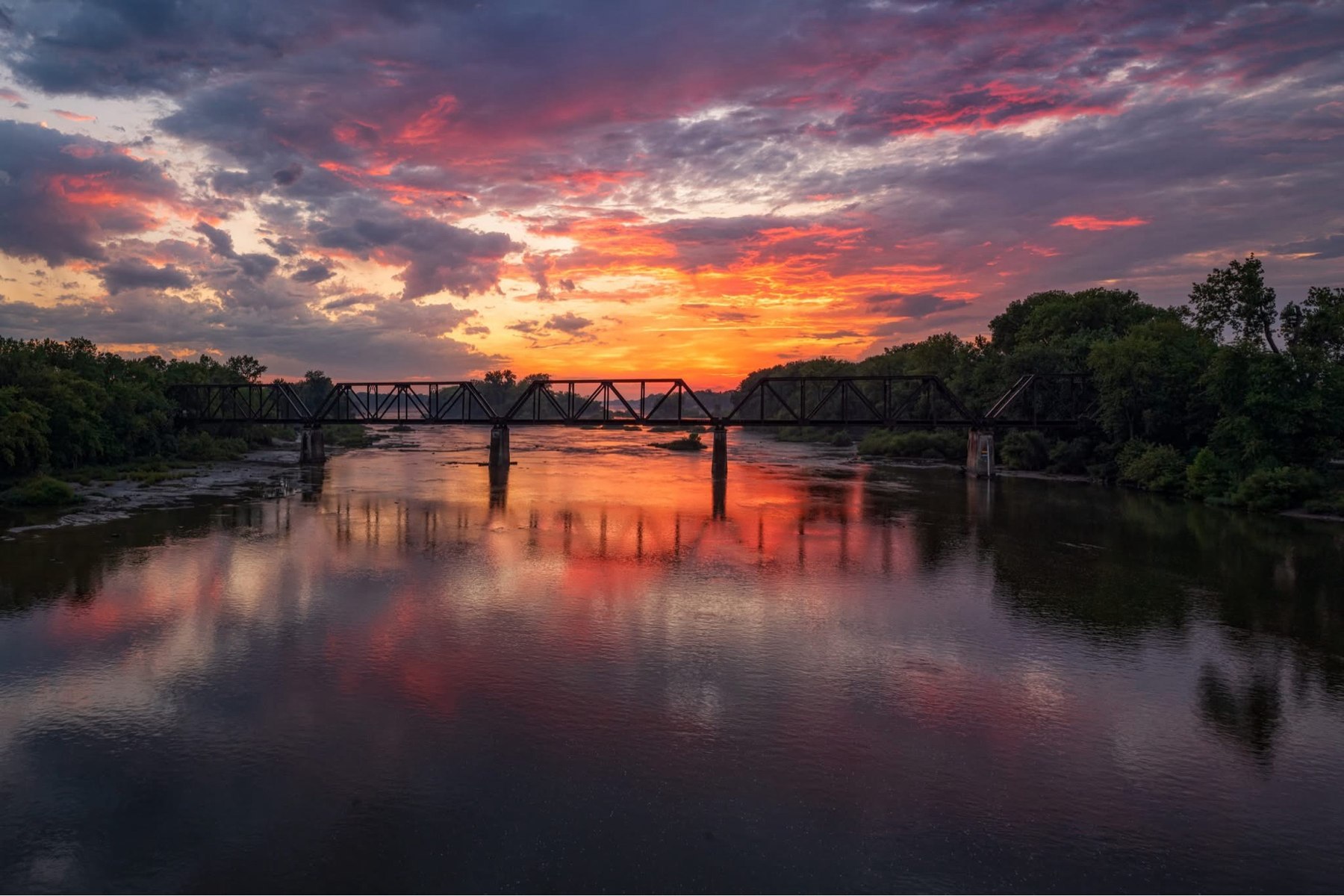 Sunset over the Maumee River and a railroad trestle bridge near Grand Rapids, Ohio